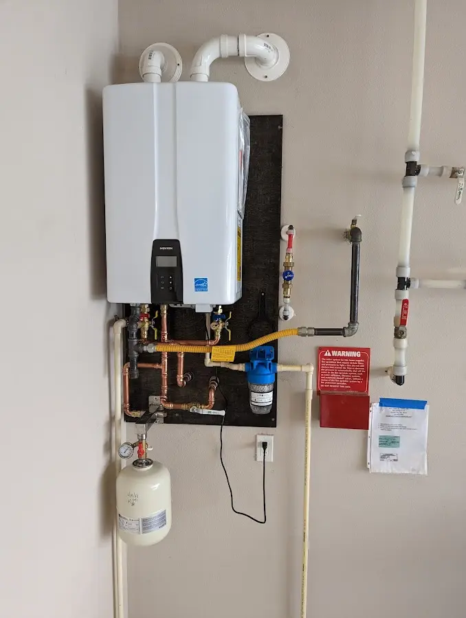 Professional plumber installing copper piping in a Gifford home